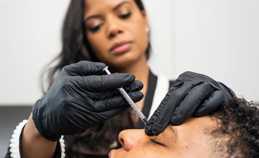 Dr. Landford applying BOTOX injections to one of her male patients