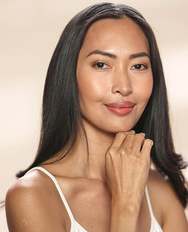 Woman looking forward with her hand up to her chin